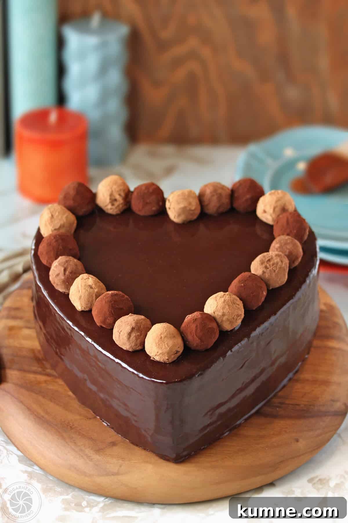 Truffle-Topped Heart Cake - A chocolate heart shaped cake with a glaze and homemade truffles lining the top.