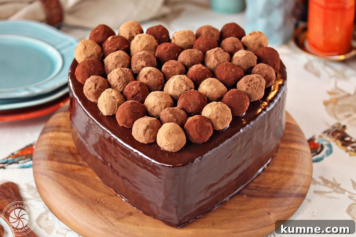 Truffle-Topped Heart Cake - Heart cake covered with glaze and truffles covering the top.