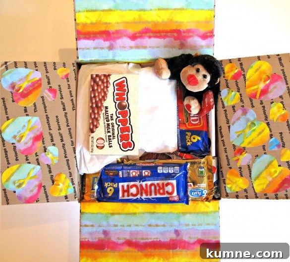 Valentine Sugar Cookies for Care Packages: Military Edition #9 3 The flaps of the care package are decorated; two are covered with rainbow-striped wrapping paper and two have hearts cut from the rainbow paper. Each heart has a yellow "support our troops" ribbon in the middle.
