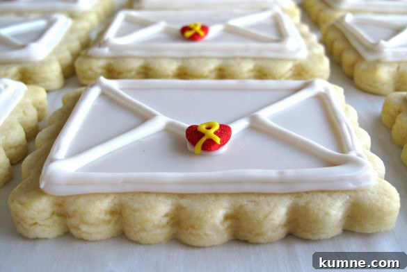 Valentine Sugar Cookies for Care Packages: Military Edition #9 5 Valentine Envelope Sugar Cookies edge closeup showing ¼" thickness of the scalloped edge and the 3-dimensional icing with the envelope lines piped on top of the flat white icing.