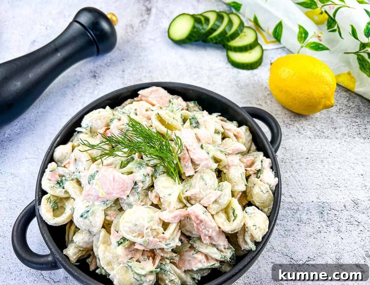 Salmon pasta salad in a black dish.