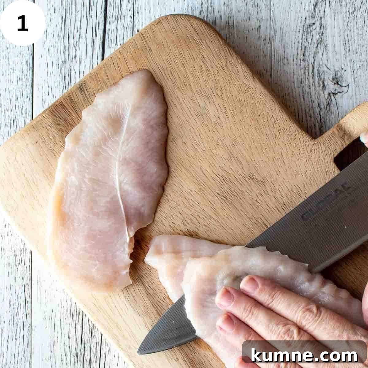 Slicing chicken breast in half.