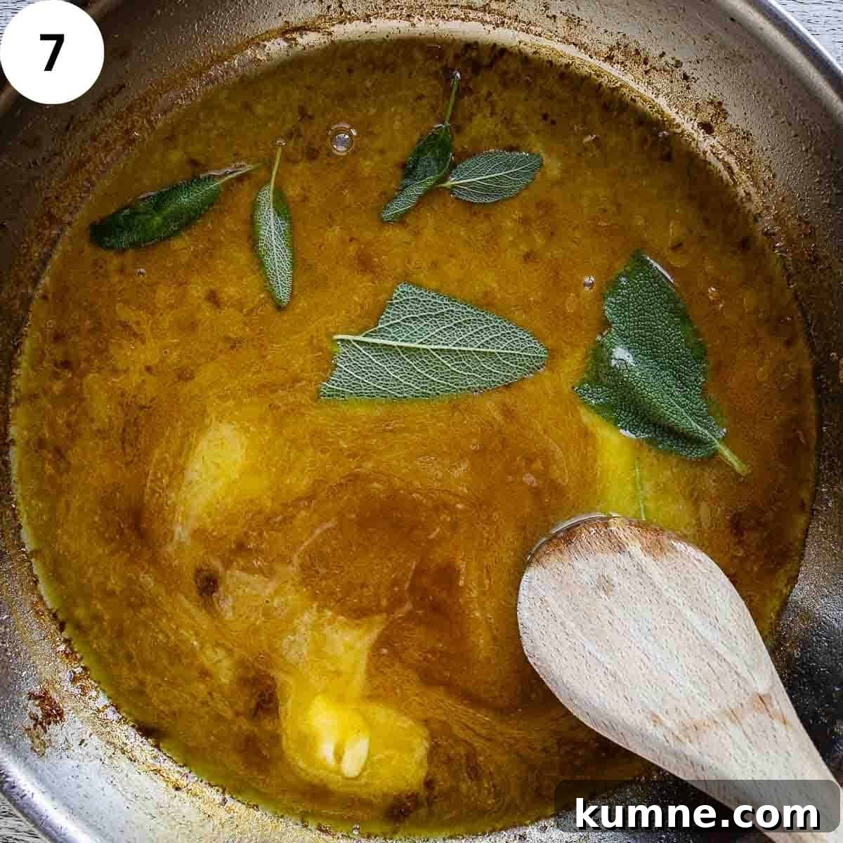 Sage leaves and butter being stirred into a sauce in a frying pan.