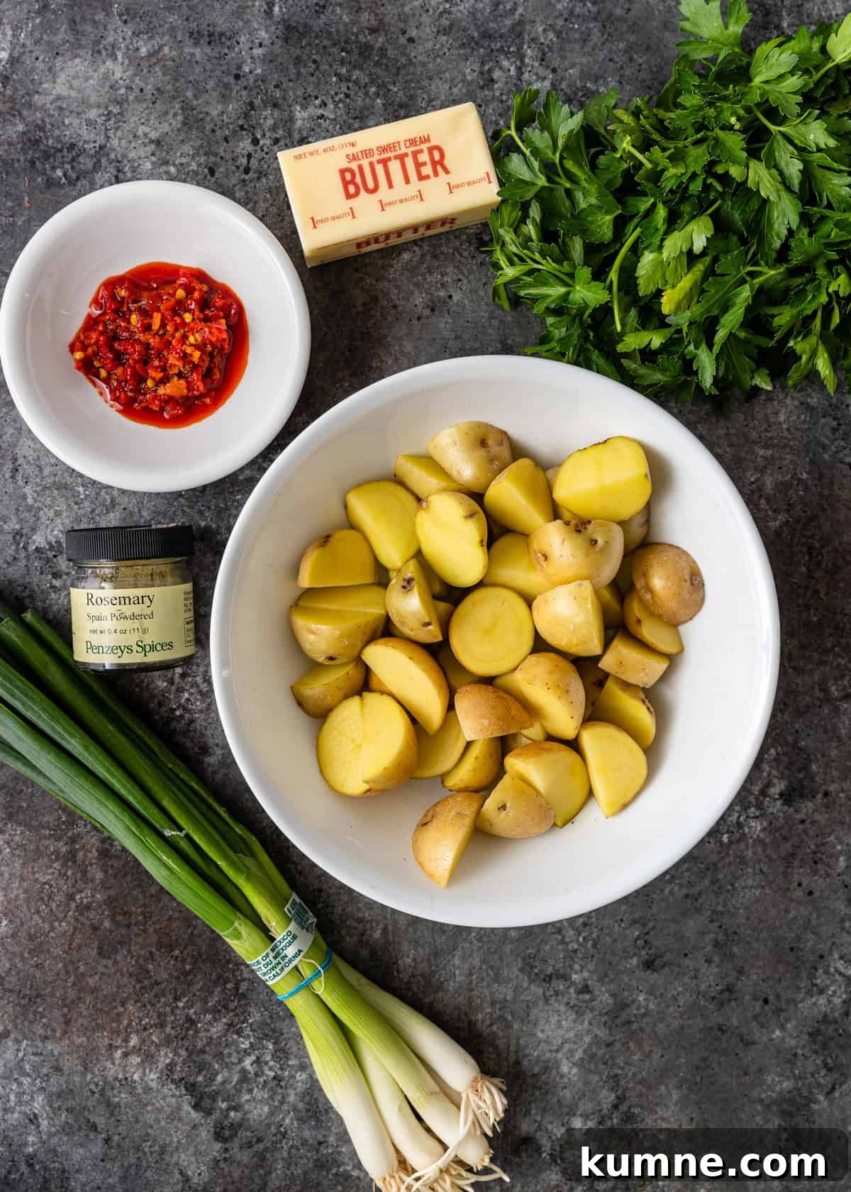 Spicy Calabrian Roasted Potatoes Recipe 3 overhead: ingredients to make potatoes and peppers in bowls on a counter