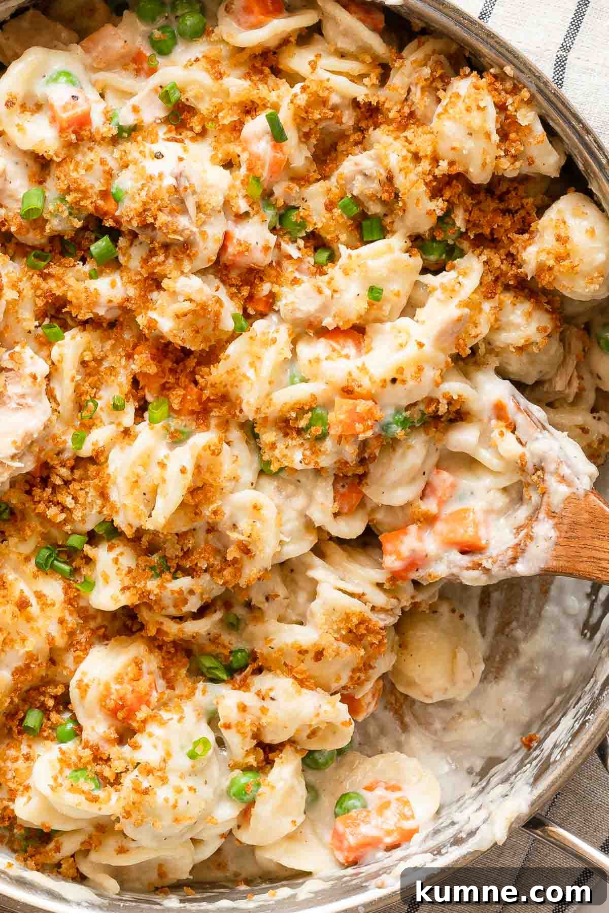 One-Pot Stovetop Tuna Casserole Recipe 12 pot of tuna casserole with wooden spoon.
