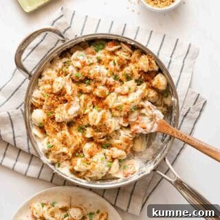 pan of tuna noodle casserole with wooden spoon.