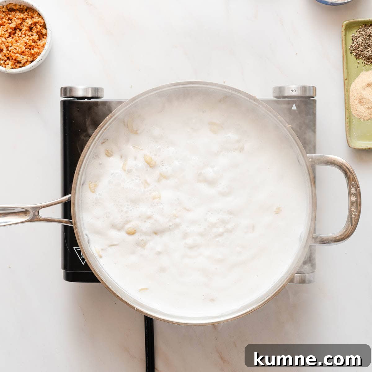 One-Pot Stovetop Tuna Casserole Recipe 5 milk and pasta cooking in a shallow pot.