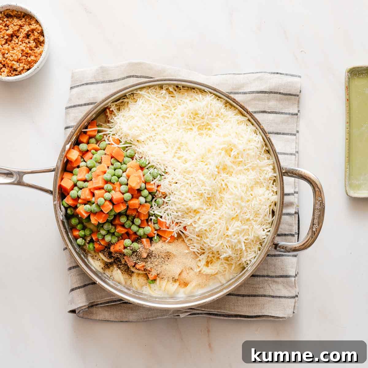One-Pot Stovetop Tuna Casserole Recipe 7 ingredients for tuna casserole in shallow pot.