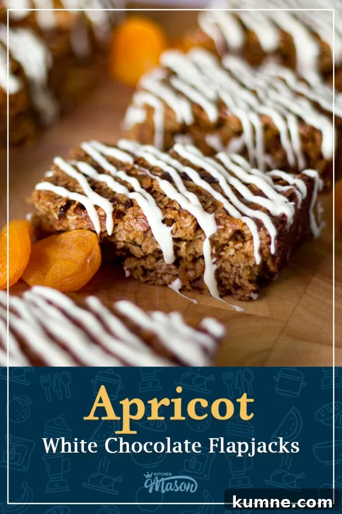 Chewy Apricot and White Chocolate Flapjack Recipe for Snacktime 13 A slice of apricot white chocolate flapjack with dried apricots on the side. A text overlay says 'apricot white chocolate flapjacks'.