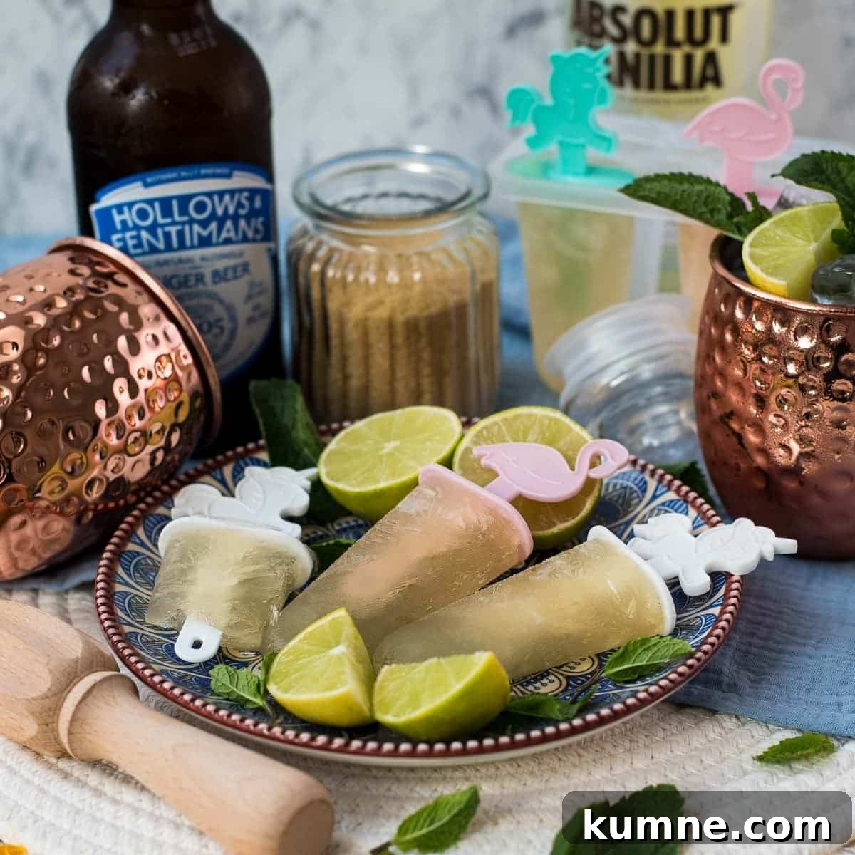Gorgeous and refreshing Moscow mule popsicles placed on patterned plate.