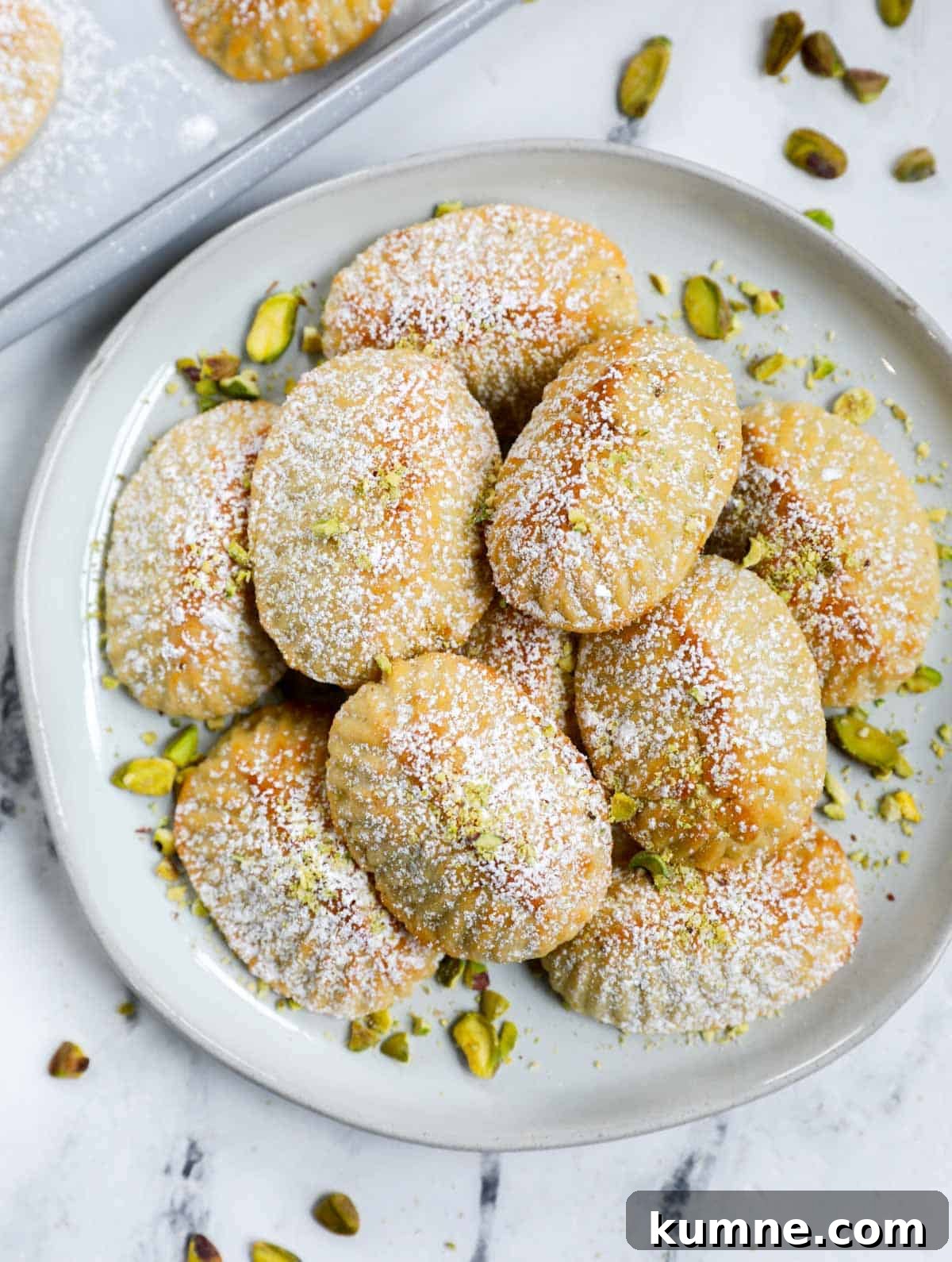 Photo of pistachio maamoul cookies on a plate.