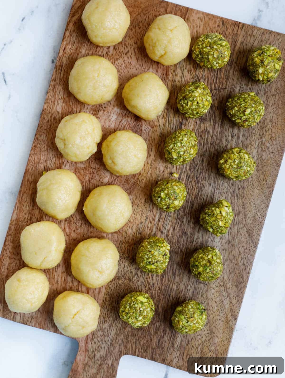 Pistachio ball and maamoul dough on a board.