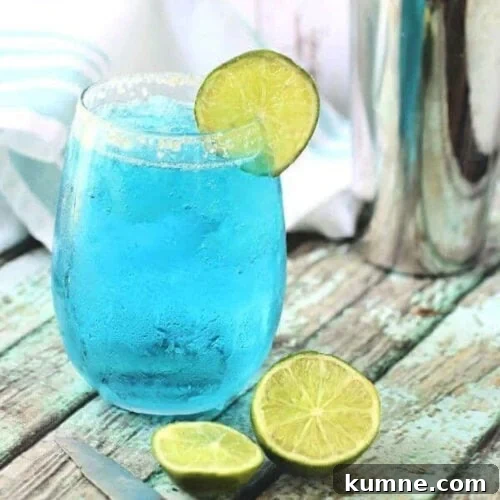 Blue cocktail with a lime garnish for feature image.