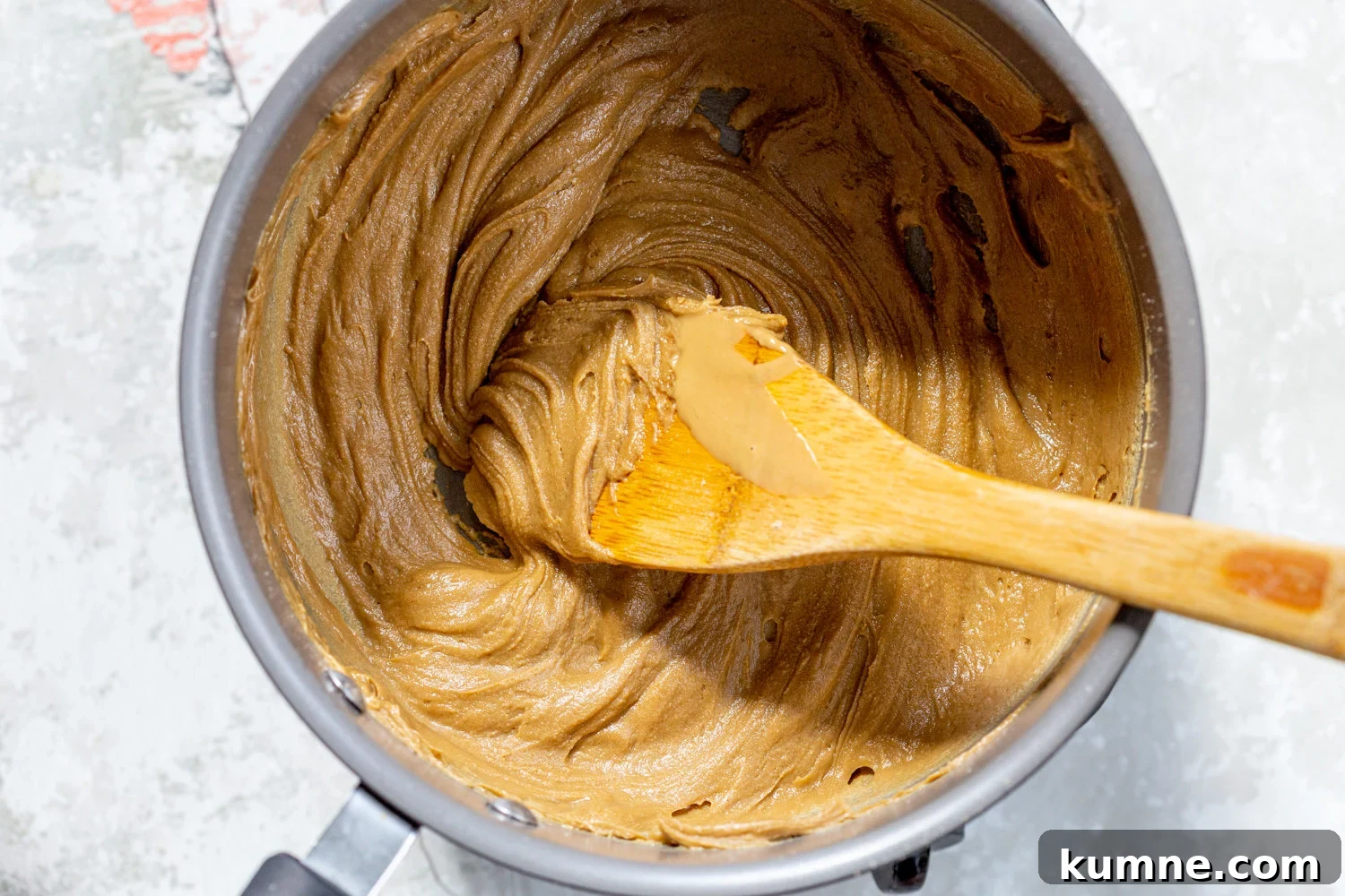 Sunbutter and maple syrup in a saucepan for our Sunbutter Granola Bars