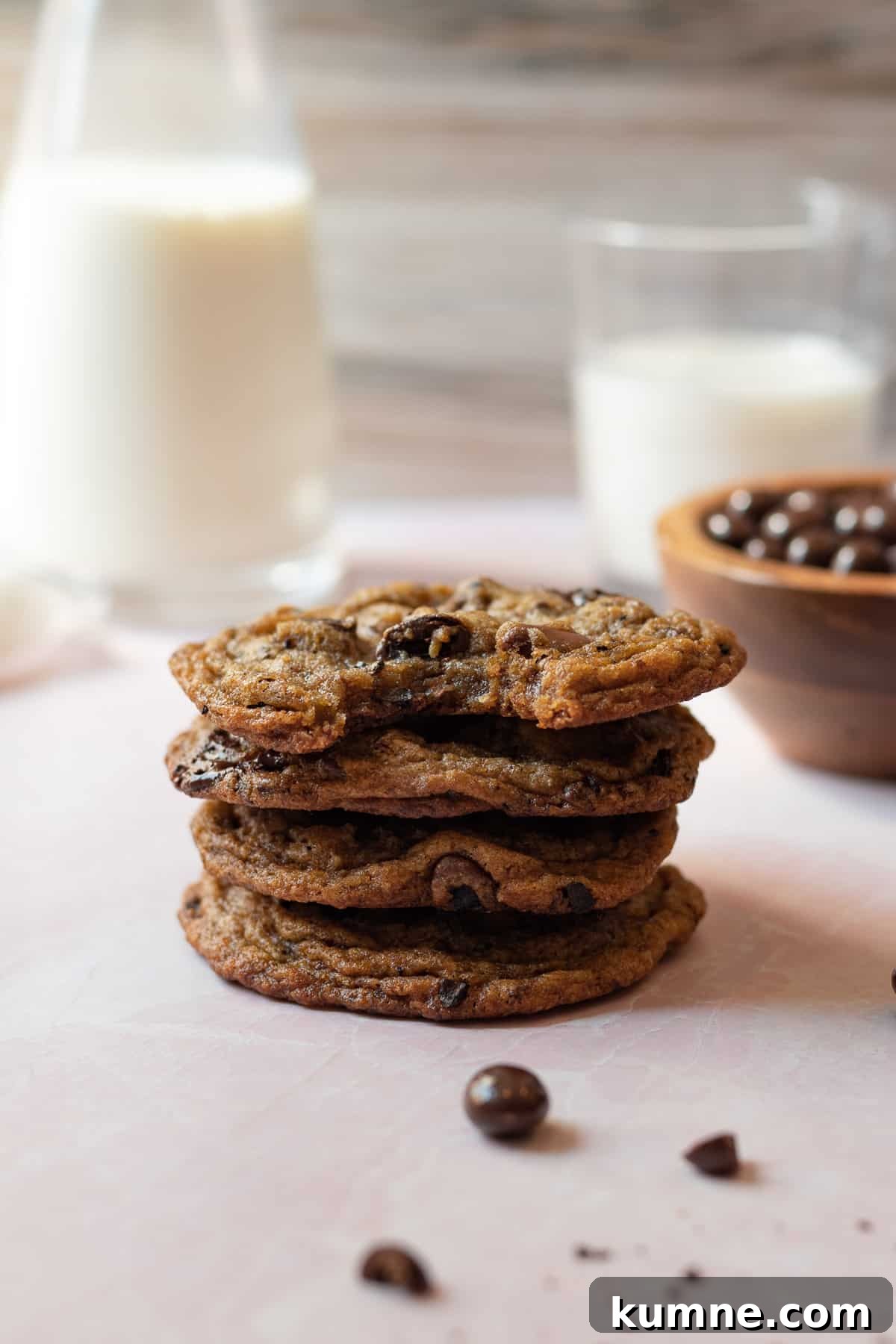 Espresso Chocolate Chip Cookies Recipe for Rich Coffee Flavor 3 stack of espresso chocolate chip cookies with glasses of milk in the background