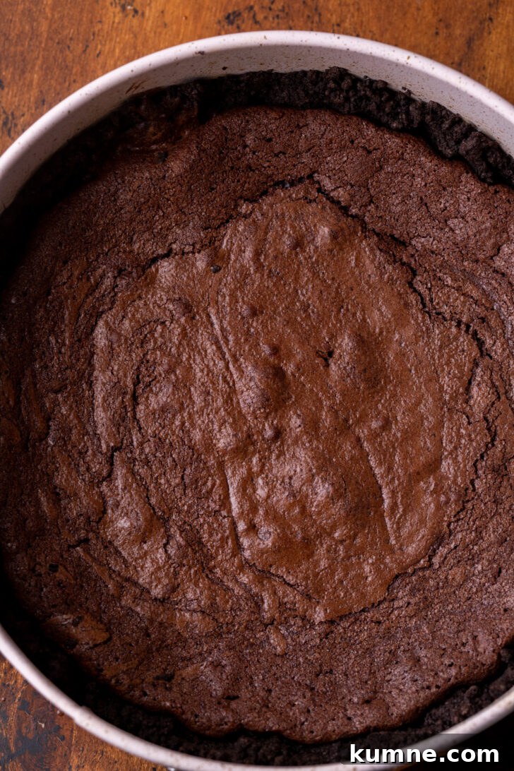 Decadent Mississippi Mud Pie Recipe — Classic Chocolate Dessert 5 Baked brownie in the pan on top of the crust.