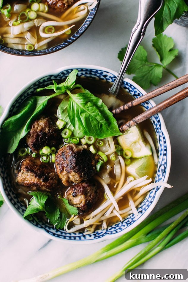 Royal pho broth with cabbage ribbons and vietnamese spiced pork meatballs - Incredibly easy and comforting pho soup that also happens to be grain free // paleo! Brimming with fragrant aromatics, tender ribbons of cabbage instead of noodles, and delightfully delicious pork meatballs.