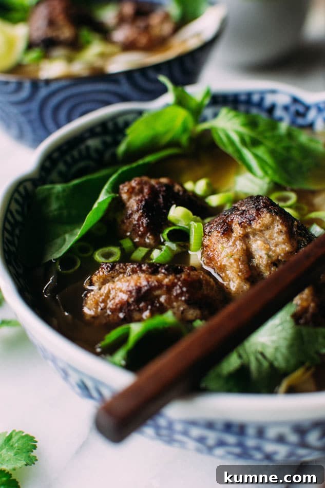 Royal pho broth with cabbage ribbons and vietnamese spiced pork meatballs - Incredibly easy and comforting pho soup that also happens to be grain free // paleo! Brimming with fragrant aromatics, tender ribbons of cabbage instead of noodles, and delightfully delicious pork meatballs.