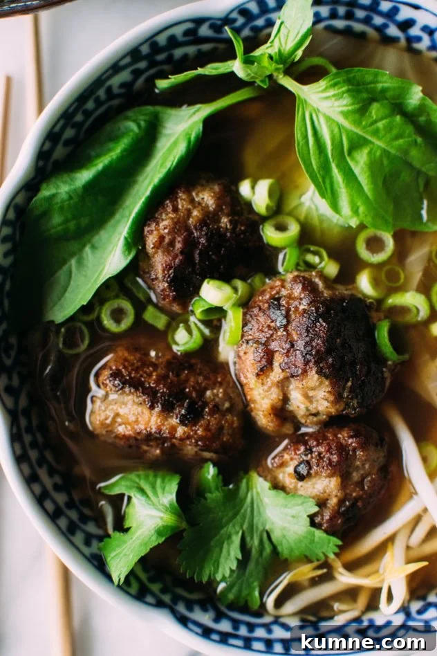 Royal pho broth with cabbage ribbons and vietnamese spiced pork meatballs - Incredibly easy and comforting pho soup that also happens to be grain free // paleo! Brimming with fragrant aromatics, tender ribbons of cabbage instead of noodles, and delightfully delicious pork meatballs.