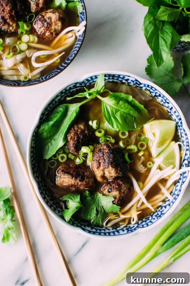 Royal pho broth with cabbage ribbons and vietnamese spiced pork meatballs - Incredibly easy and comforting pho soup that also happens to be grain free // paleo! Brimming with fragrant aromatics, tender ribbons of cabbage instead of noodles, and delightfully delicious pork meatballs.