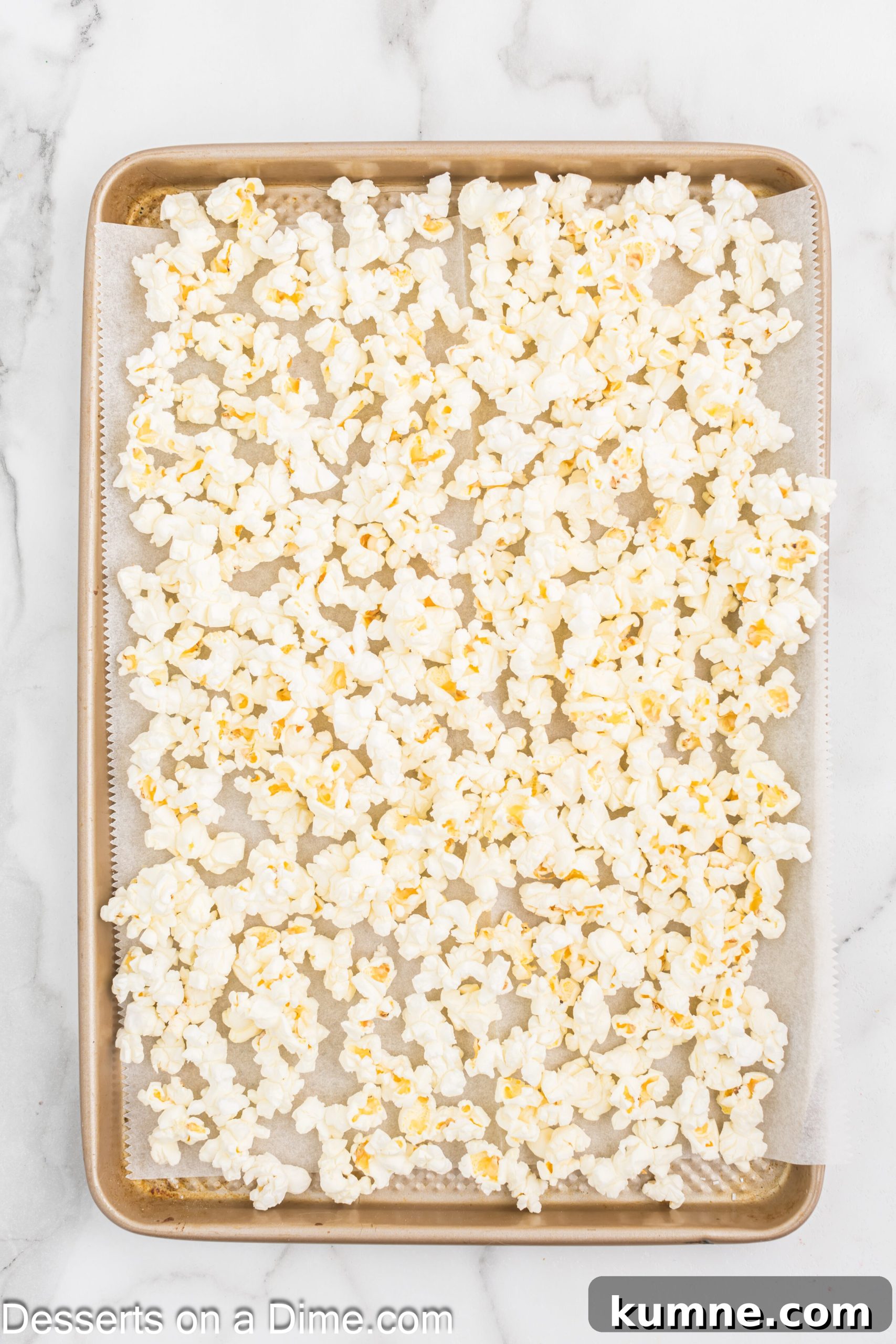 Popped popcorn on a baking sheet.