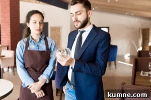 How to Become a Restaurant Manager in India: Step-by-Step Guide 2 Frowning restaurateur checking wineglass