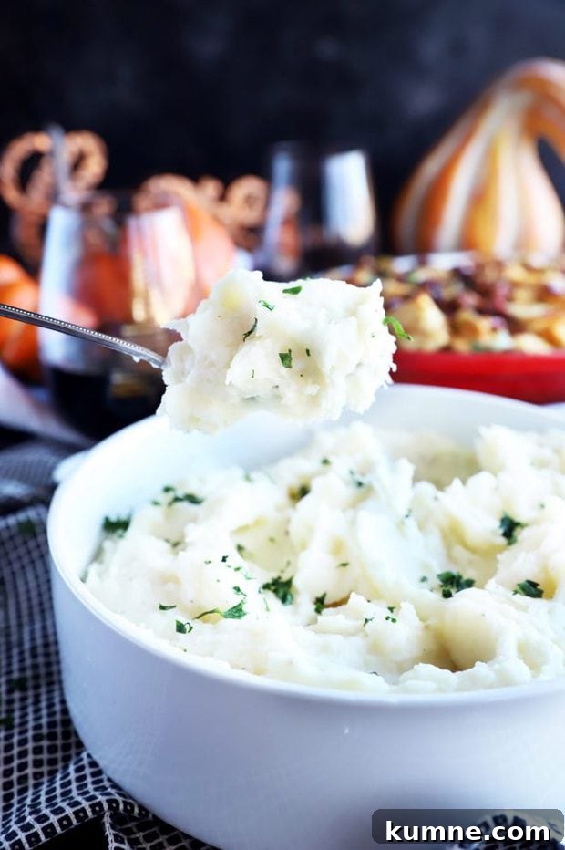 Roasted Garlic Parmesan Mashed Potatoes in the Instant Pot 3 Spooning out mashed potatoes