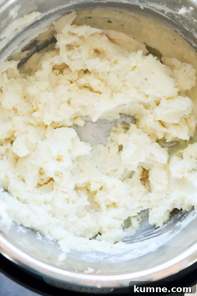 Roasted Garlic Parmesan Mashed Potatoes in the Instant Pot 7 instant pot mashed potatoes mixed together in the insert