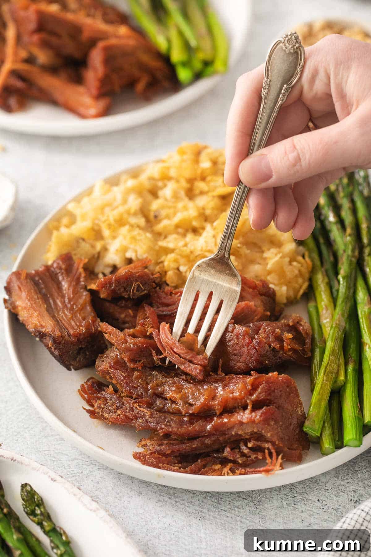 Gluten-Free Baked Ham Recipe for Flavorful Holiday Meals 2 Gluten-free ham on a plate with a fork taking a bite