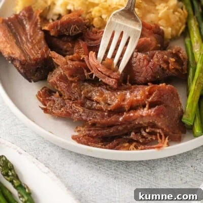 Gluten-Free Baked Ham Recipe for Flavorful Holiday Meals 6 Gluten-free ham on a plate with a fork taking a bite