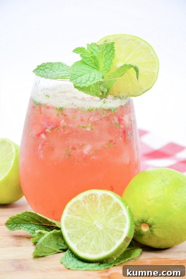 Refreshing Strawberry Mojito Recipe: How to Make the Classic Cocktail 2 a strawberry mojito garnished with lime and mint.