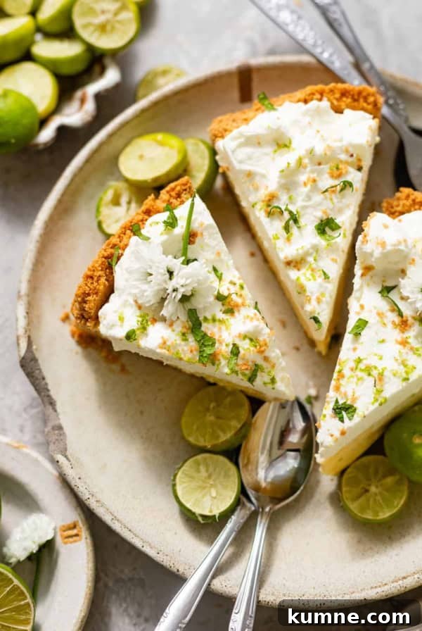 Homemade Banana Pudding Recipe: Classic from Scratch 11 sliced key lime pie on a ceramic plate with fresh key limes, edible flowers, and serving spoons.