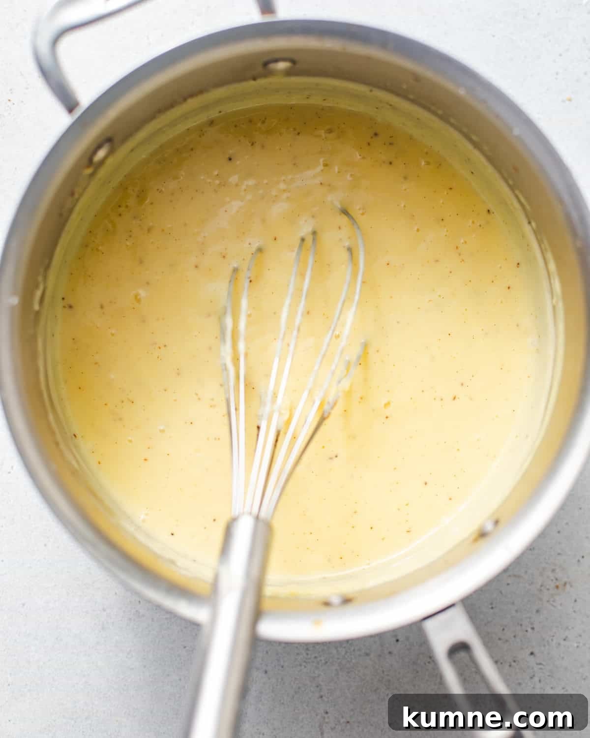 Homemade Banana Pudding Recipe: Classic from Scratch 6 vanilla custard in a saucepan with a whisk.