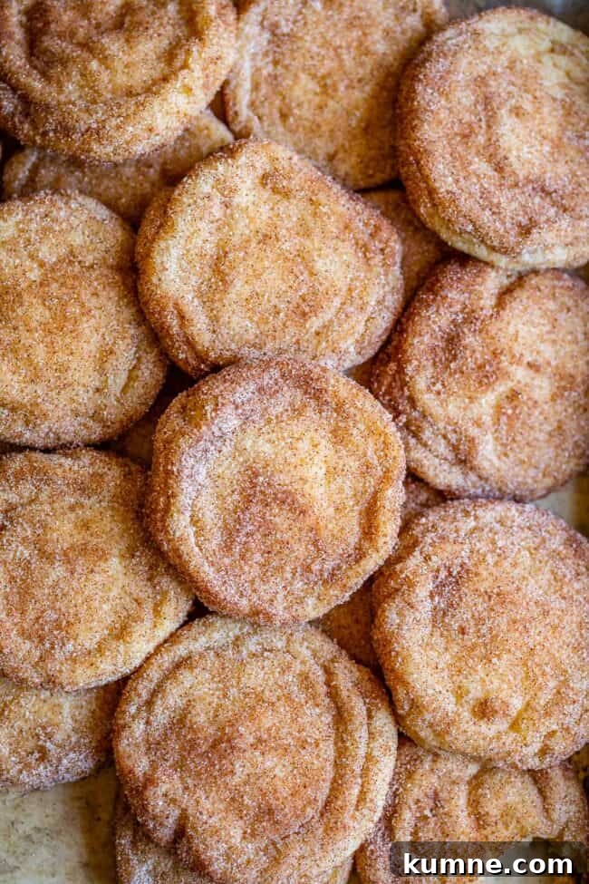 snickerdoodle cookies spread out on a pan.