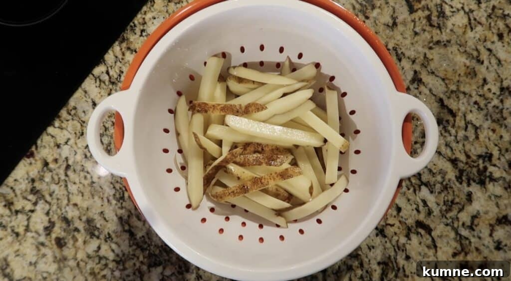 Potato sticks drained in a colander