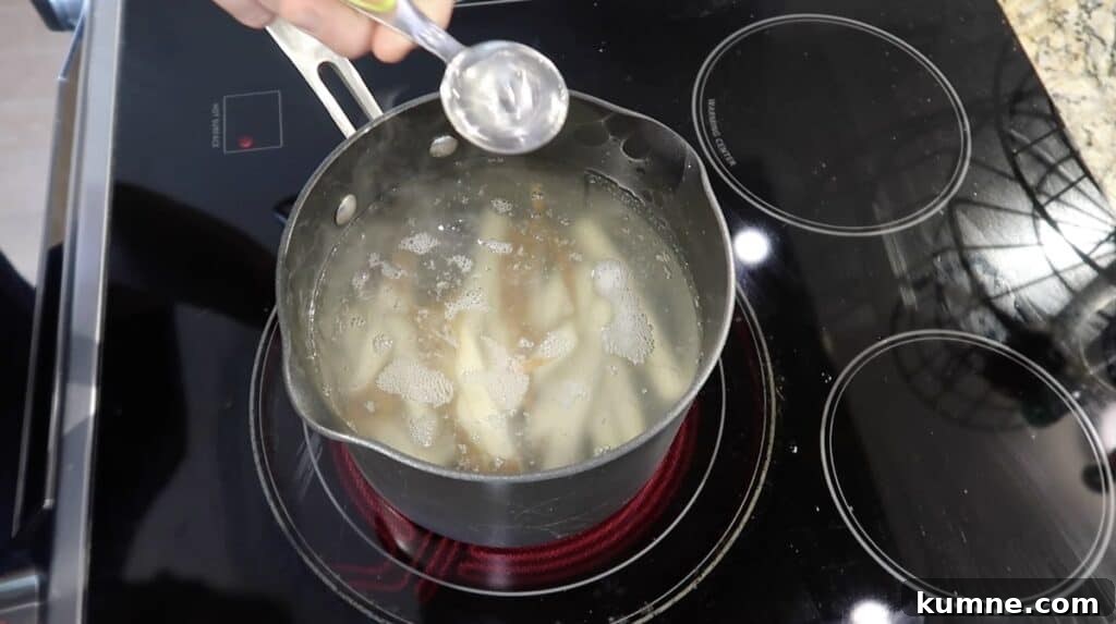 Adding white vinegar to pot