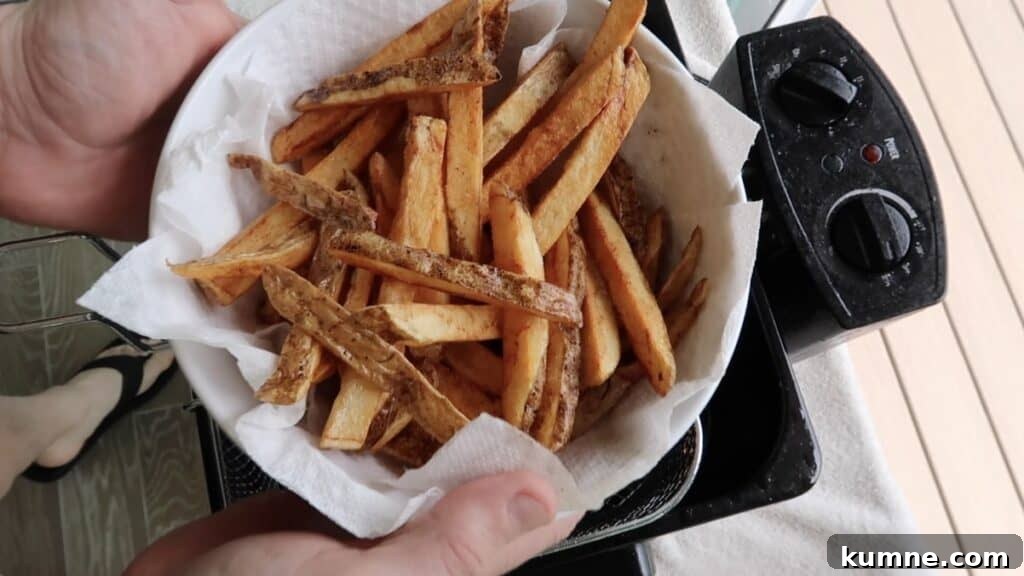 French Fries transferred to a paper towel-lined bowl