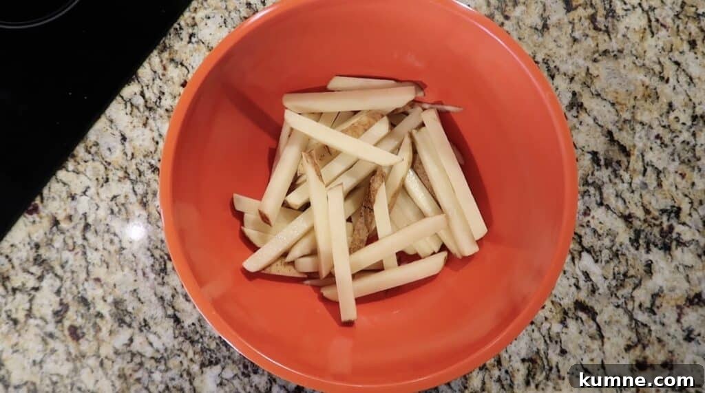 Sliced potato sticks in bowl