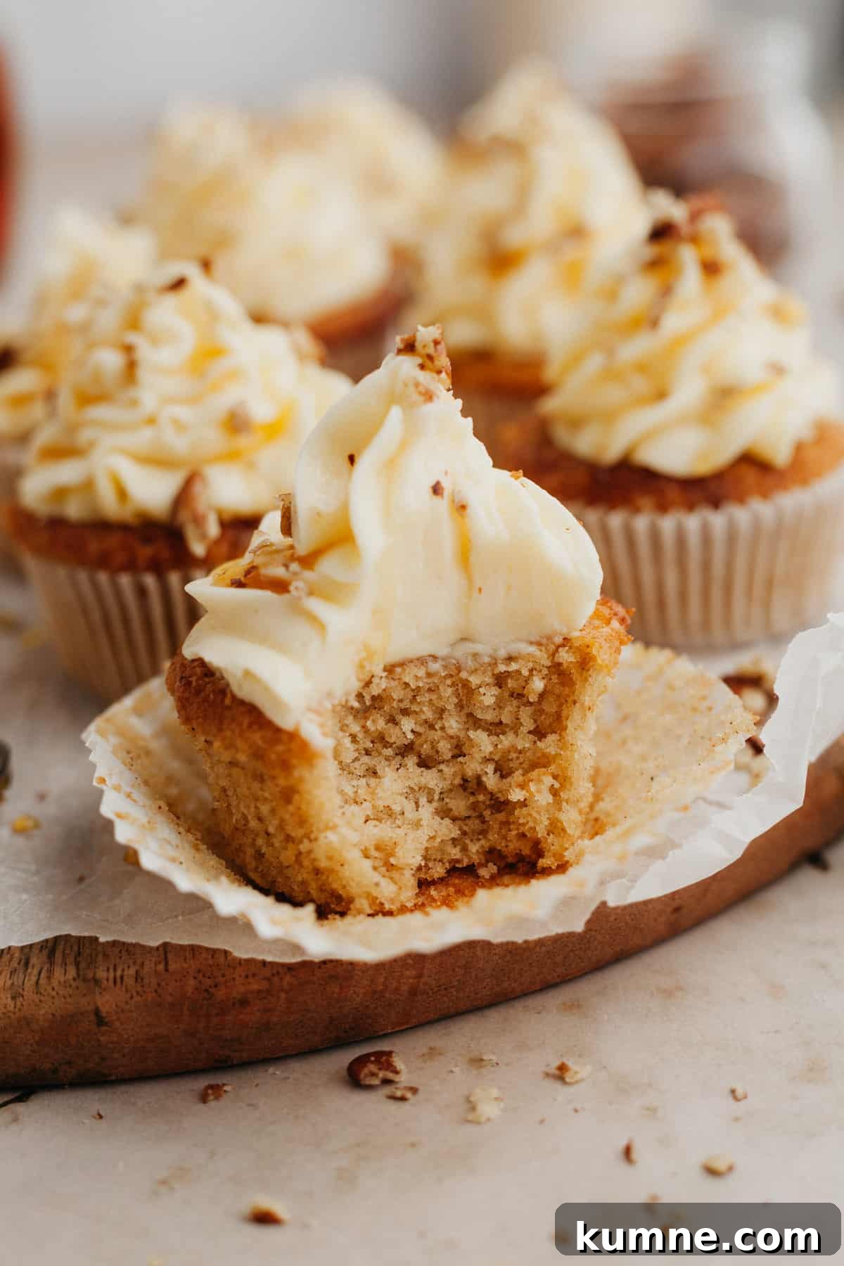 Maple Cupcakes Recipe with Brown Butter Frosting 2 A close up of a maple cupcake with a bite taken out of it
