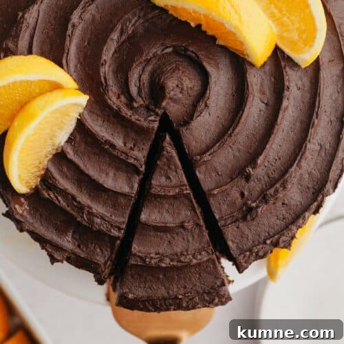 An overhead shot of a slice of chocolate cake being removed from the cake.