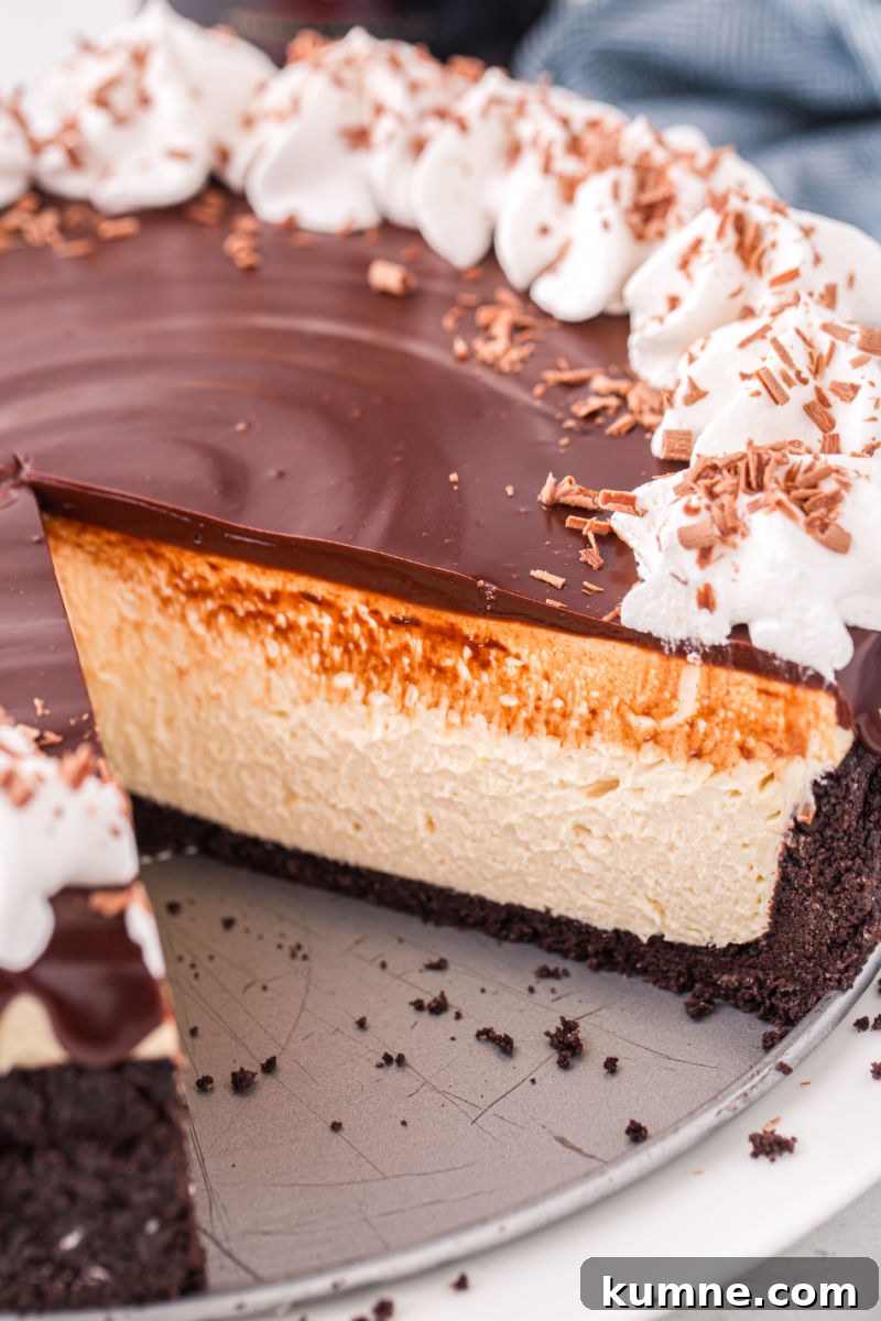 baileys cheesecake with a slice taken out to show the layers