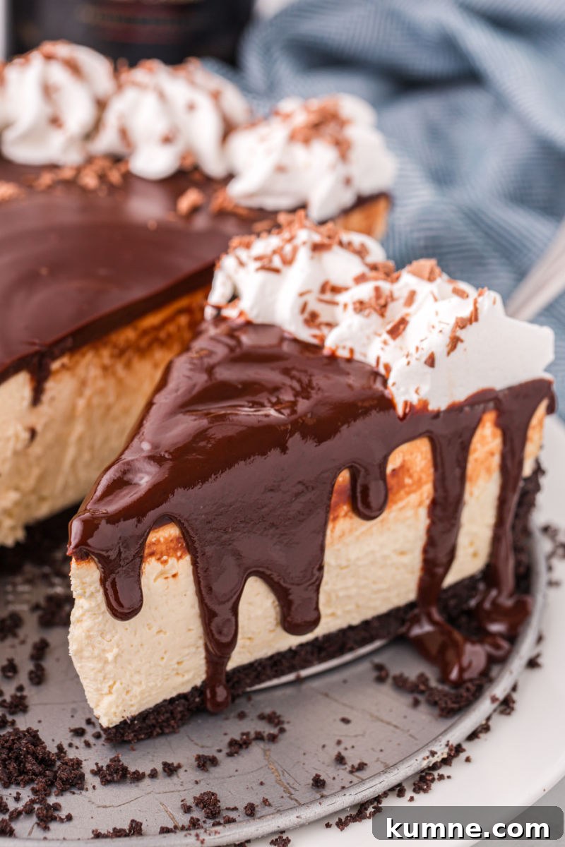 slice of baileys cheesecake with chocolate ganache running down the sides
