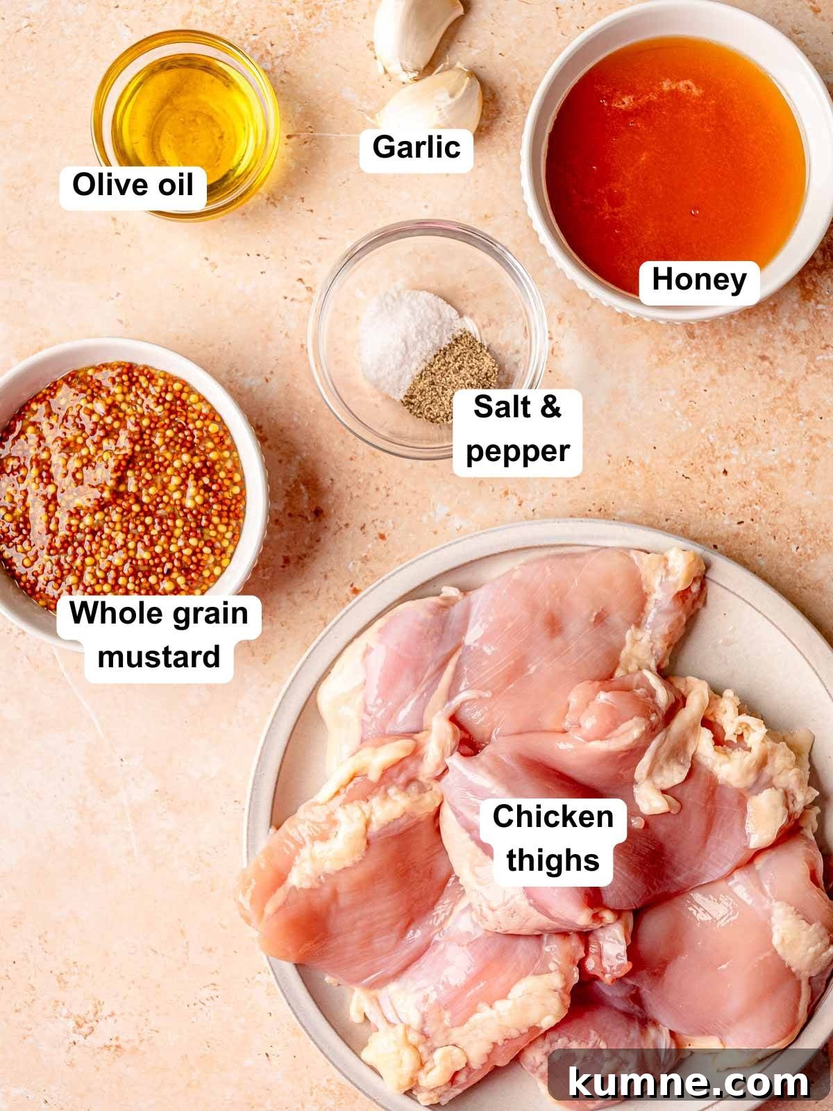 Honey Mustard Grilled Chicken Recipe for Juicy, Flavorful Results 3 Labeled ingredients for honey mustard grilled chicken including chicken thighs, whole grain mustard, honey, garlic, olive oil, salt, and pepper.