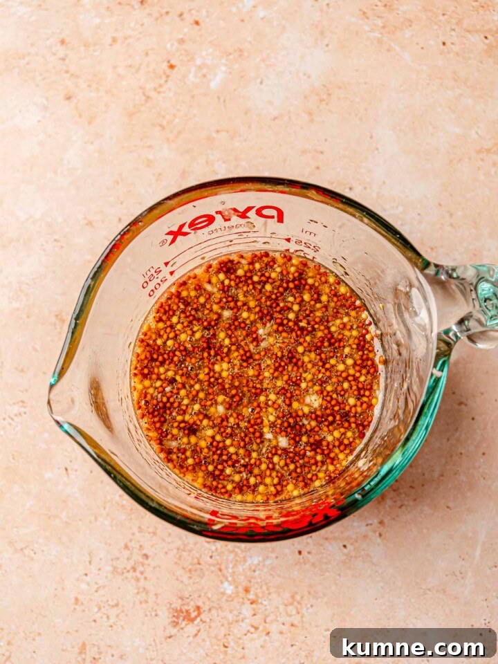 Honey Mustard Grilled Chicken Recipe for Juicy, Flavorful Results 4 Honey mustard marinade made with whole grain mustard and olive oil in a measuring cup.