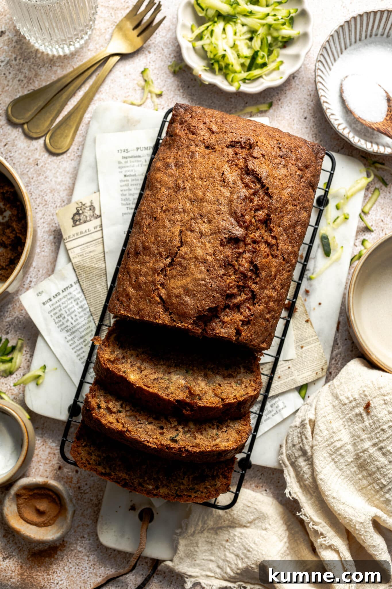 Moist Zucchini Bread Recipe with Cinnamon and Walnuts 7 sliced zucchini bread on a wire rack.