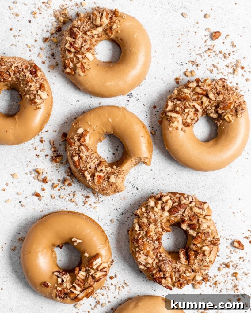 Baked Spiced Brown Sugar Donuts Recipe for Fall Flavor 2 Baked Spiced Brown Sugar Donuts are glazed in a butter maple glaze and garnished with a crushed pecan crust