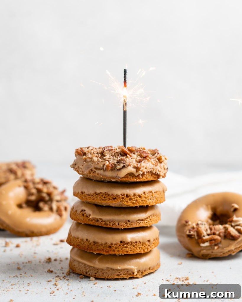 Baked Spiced Brown Sugar Donuts Recipe for Fall Flavor 3 Baked Spiced Brown Sugar Donuts are glazed in a butter maple glaze and garnished with a crushed pecan crust