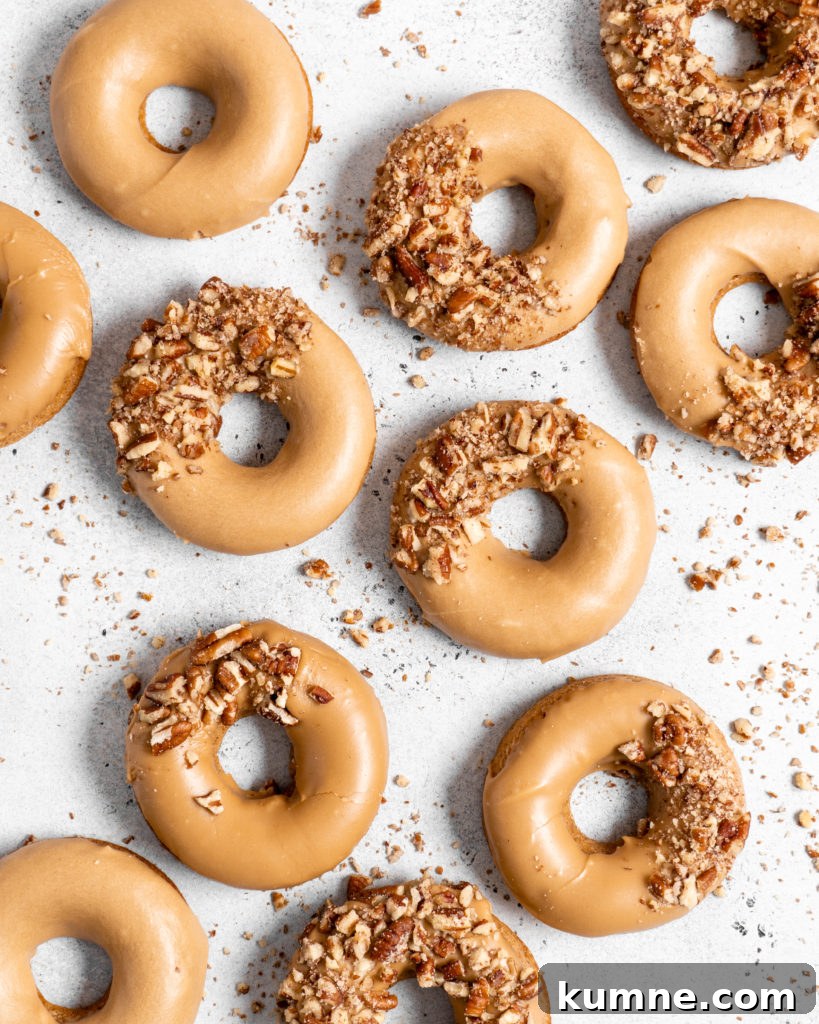 Baked Spiced Brown Sugar Donuts Recipe for Fall Flavor 4 Baked Spiced Brown Sugar Donuts are glazed in a butter maple glaze and garnished with a crushed pecan crust