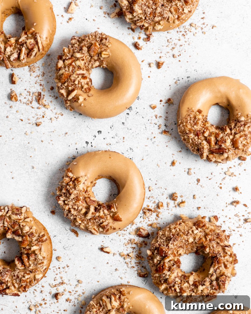 Baked Spiced Brown Sugar Donuts Recipe for Fall Flavor 5 Baked Spiced Brown Sugar Donuts are glazed in a butter maple glaze and garnished with a crushed pecan crust