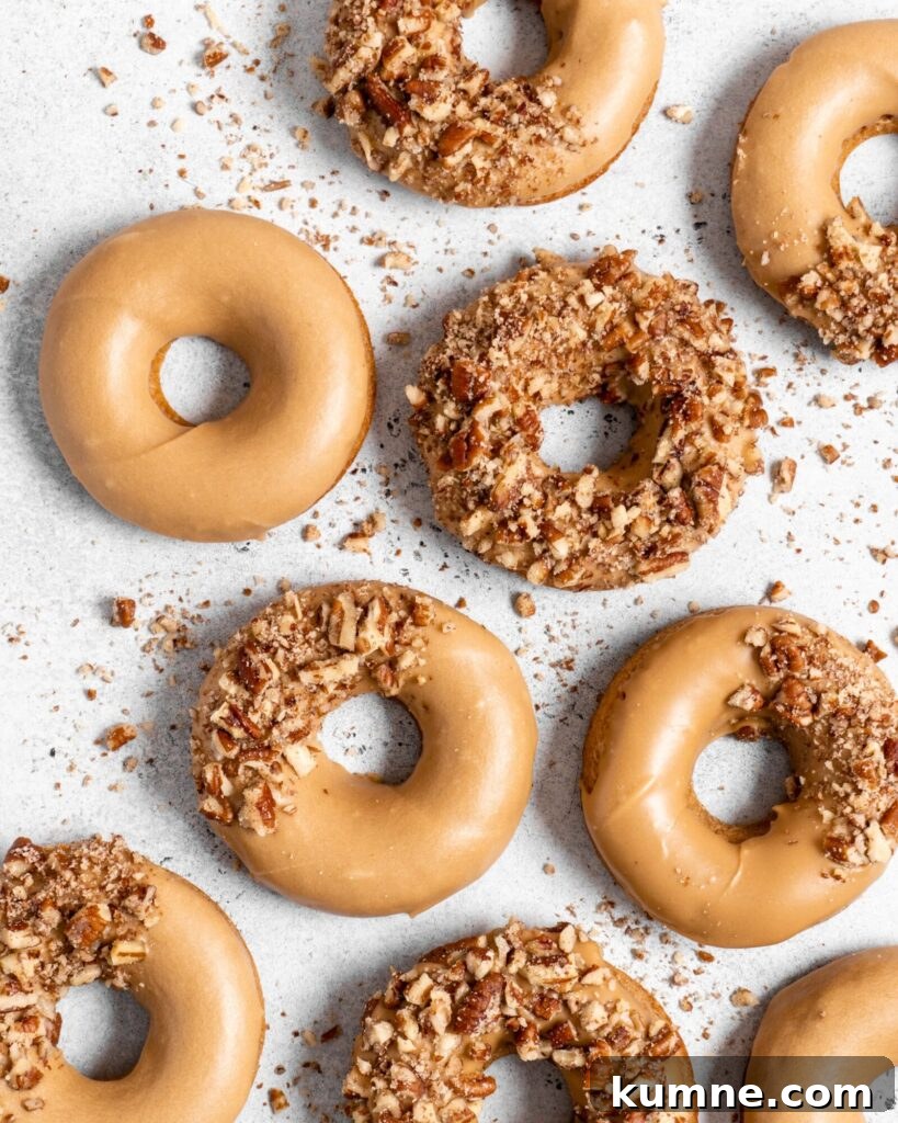 Baked Spiced Brown Sugar Donuts Recipe for Fall Flavor 8 Baked Spiced Brown Sugar Donuts are glazed in a butter maple glaze and garnished with a crushed pecan crust